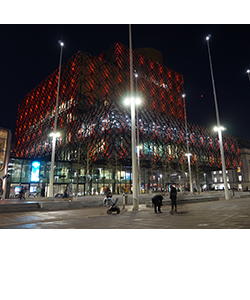 Library of Birmingham lit up with red lighting. 